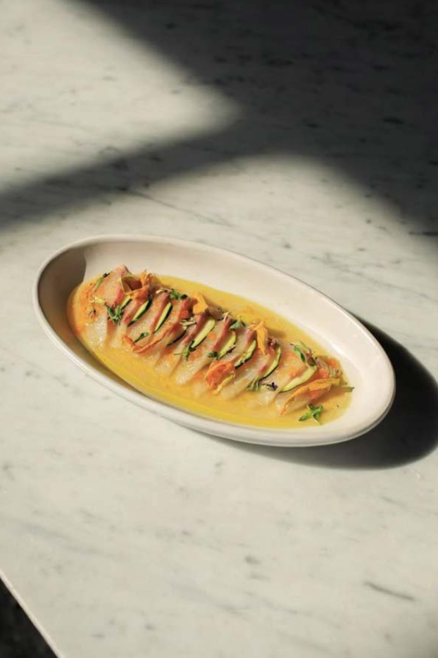 Fish in saffron broth on marble — placeholder plate